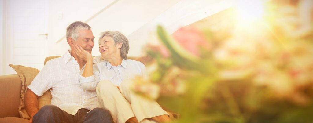Loving senior couple sitting on sofa